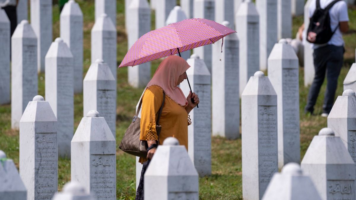 A woman visits the memorial cemetery in Potocari near Srebrenica.