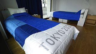 Una habitación de la villa olímpica con dos camas de cartón