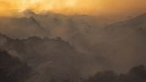 Smoke rises from a brush fire scorching at least 100 acres in the Pacific Palisades area of Los Angeles Saturday, May 15, 2021.