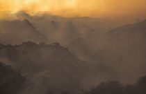 Smoke rises from a brush fire scorching at least 100 acres in the Pacific Palisades area of Los Angeles Saturday, May 15, 2021.