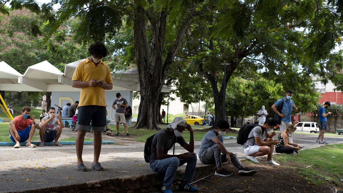 Cubans connect to wifi in Martyrs Park, Havana