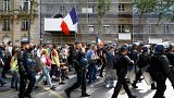 French riot mobile gendarmes walk past protesters
