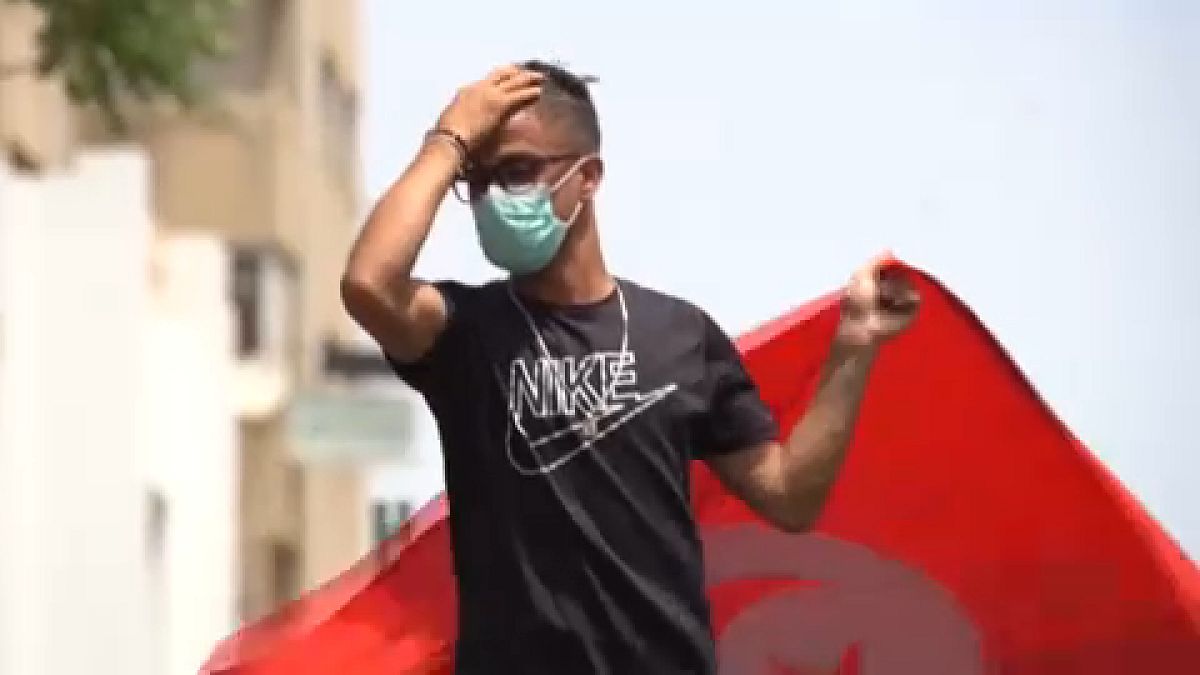 Anti-government demonstrator rallying in front of the Parliament in the capital Tunis