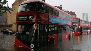 queue of buses forced to stop in the flooded road in London