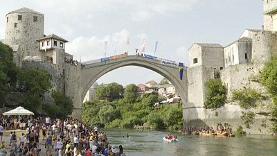 A high diver jumps into the Neretva
