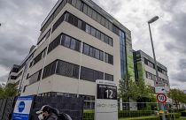 FILE - In this May 6, 2021 file photo a man with a face mask leaves the headquarters of the German biotechnology company "BioNTech" in Mainz, Germany.