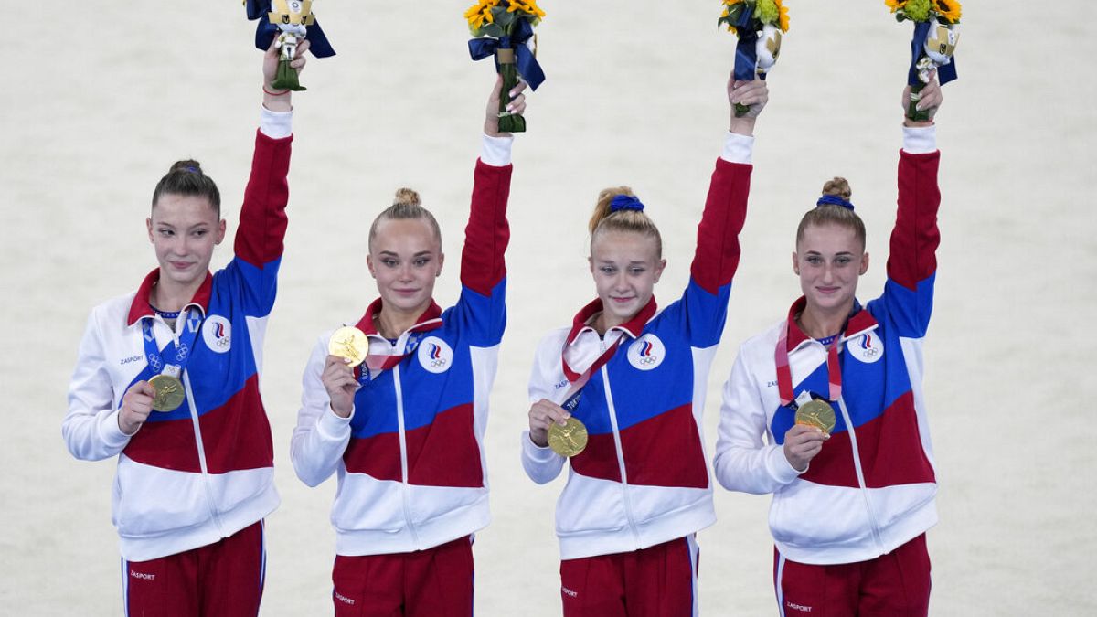 Russian Olympic Committee's artistic gymnastics women's team, from right, Liliia Akhaimova, Viktoriia Listunova, Angelina Melnikova and Vladislava Urazova celebrate.