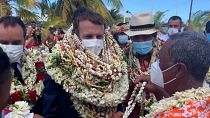 Emmanuel Macron is welcomed with garlands of flowers and seashells on Manihi Island