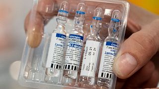 A medical worker shows vials with Russia's Sputnik V coronavirus vaccine