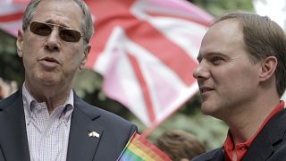 FILE: U.S. Ambassador to Romania Mark Gitenstein, left, speaks to UK Ambassador to Romania, Martin Harris, right, during the Gay Parade in Bucharest, Romania in 2011 