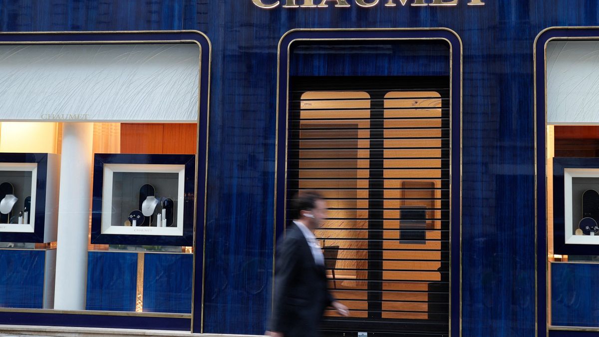 A passer-by walks past a Chaumet jewellery store located close to the Champs-Elysee avenue in central Paris, on July 27, 2021. 