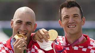 Martin Sinkovic and Valent Sinkovic of Croatia pose with the gold medal in the men's rowing pair final at the 2020 Summer Olympics, July 29, 2021, in Tokyo, Japan.