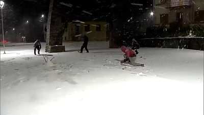 People throwing snow balls at each other.