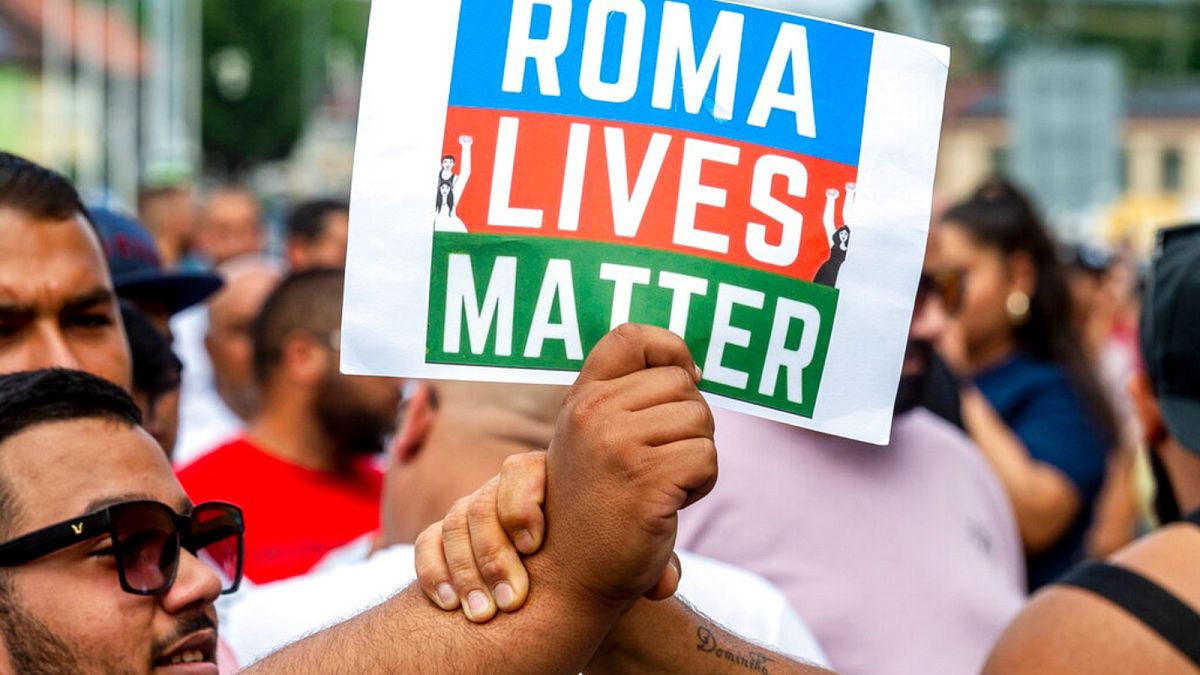 People hold a banner "Roma Lives Matter" during a rally to honor a Roma man Stanislav Tomas who died after police officers held him in Teplice, Czech Republic, June 26.