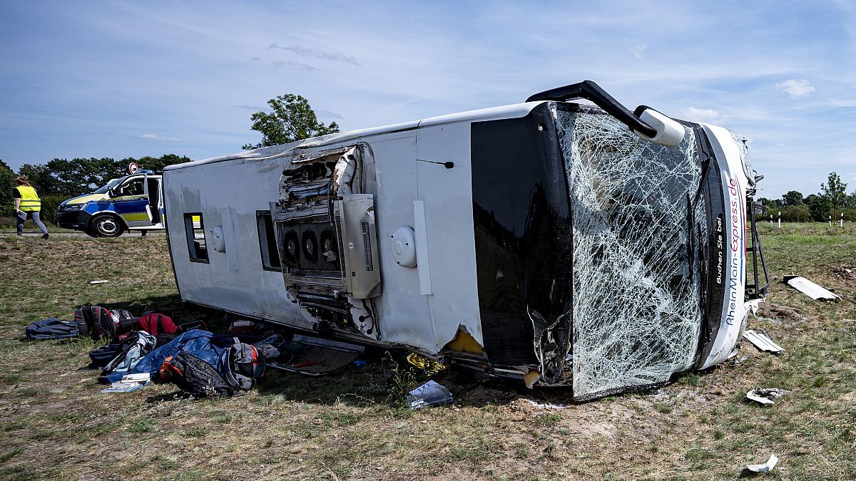 The crashed bus lies on its side on the Autobahn 13 near Berlin.