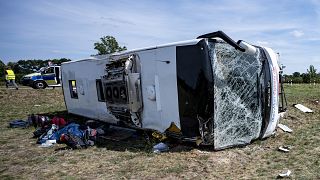 The crashed bus lies on its side on the Autobahn 13 near Berlin.