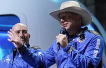 Jeff Bezos, right, founder of Amazon and space tourism company Blue Origin, describes its manned flight experience.