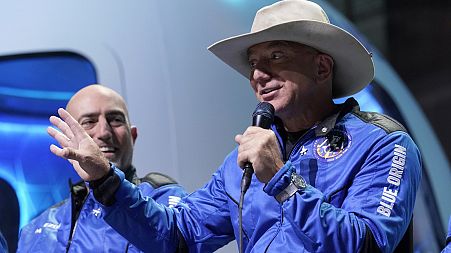 Jeff Bezos, right, founder of Amazon and space tourism company Blue Origin, describes its manned flight experience.