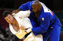 Aaron Wolf of Japan, left, and Teddy Riner of France compete during their gold medal match in team judo competition at the 2020 Summer Olympics, Saturday, July 31, 2021,.