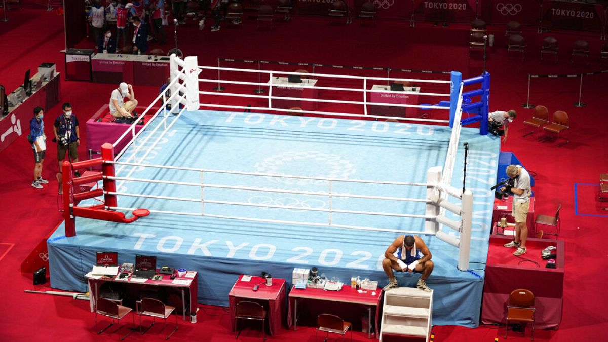 Eliad Mourad, of France refuses to leave the ring after losing a men's super heavyweight over 91-kg boxing match against Britain's Frazer Clarke at the 2020 Summer Olympics.