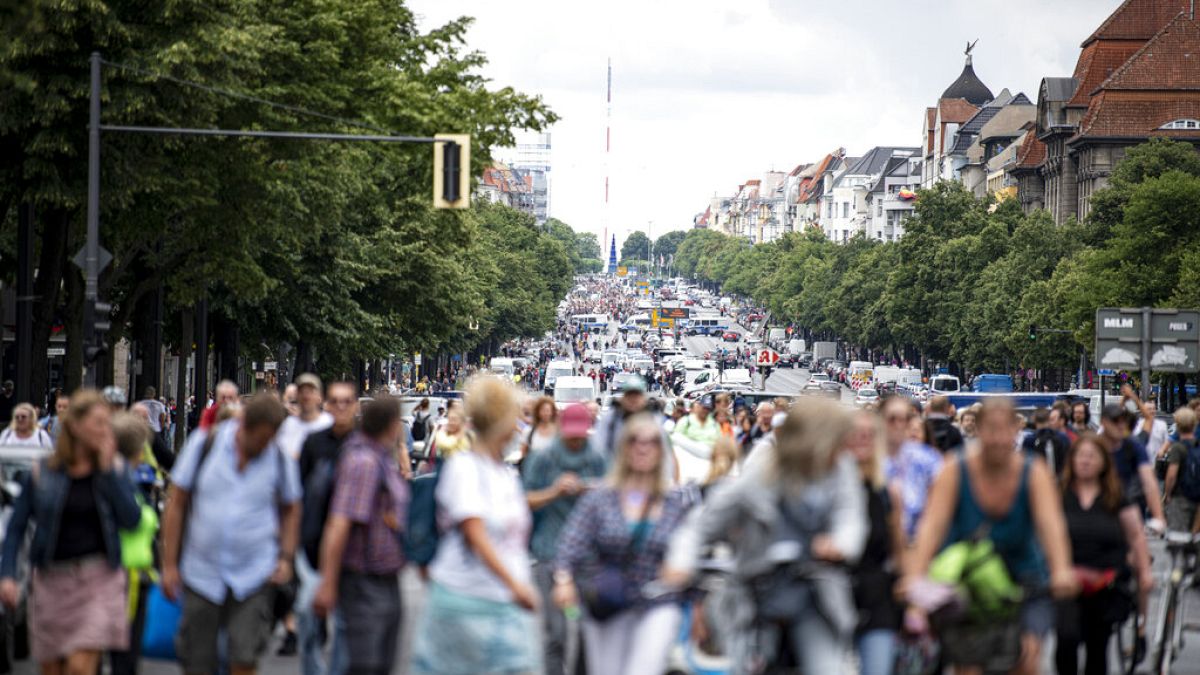 Demonstrators walk along Bismarckstrasse in Berlin, Sunday Aug. 1, 2021, during a protest against coronavirus restrictions.