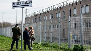 Inmates' relative stand outside the Sant’Anna prison in Modena, Emilia-Romagna, in one of Italy's quarantine red zones on March 9, 2020.