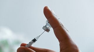 A doctor prepares a dose of the Pfizer/BioNTech Covid-19 vaccine at the prefecture in Lille, northern France