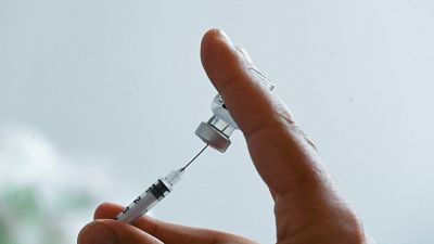 A doctor prepares a dose of the Pfizer/BioNTech Covid-19 vaccine at the prefecture in Lille, northern France