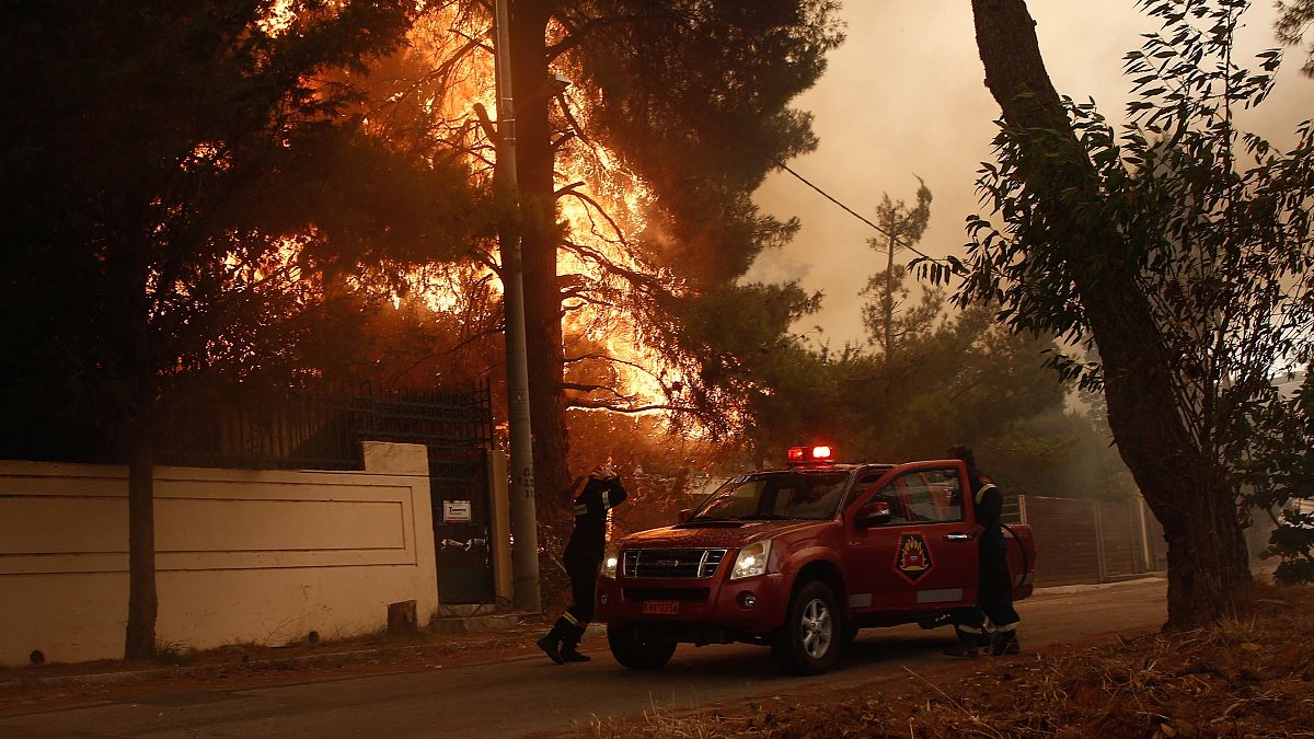 Tűzoltók érkeznek az Athén Sztamata nevű külvárosában pusztító erdőtűz helyszínére 2021. július 27-én.