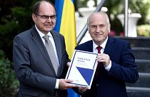 Christian Schmidt, new head of Bosnia's Office of the High Representative or OHR (L) with Valentin Inzko, during a ceremony Sarajevo, Bosnia, Aug. 2, 2021.
