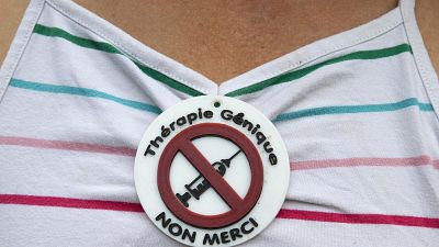 Someone takes part in an anti-vaccine rally in France. Someone takes part in an anti-vaccine rally in France.