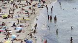 People sunbath in the Mediterranean sea at the Prophete beach, in Marseille