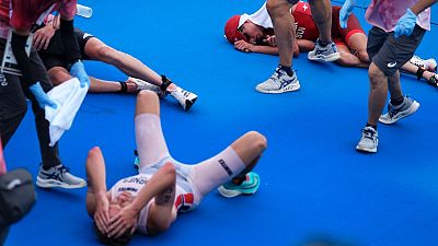 The gold, silver and bronze medal winners of the men's triathlon event collapsed after crossing the finish line in Tokyo