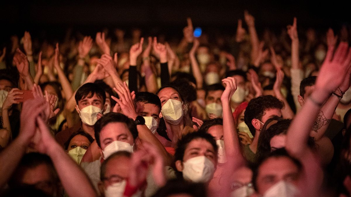 People take part in a music concert in Barcelona, Spain, Saturday, March 27, 2021. 