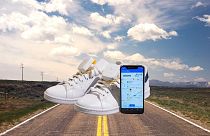 Ashirase vibration device attached to shoes and Ashirase smartphone app screen