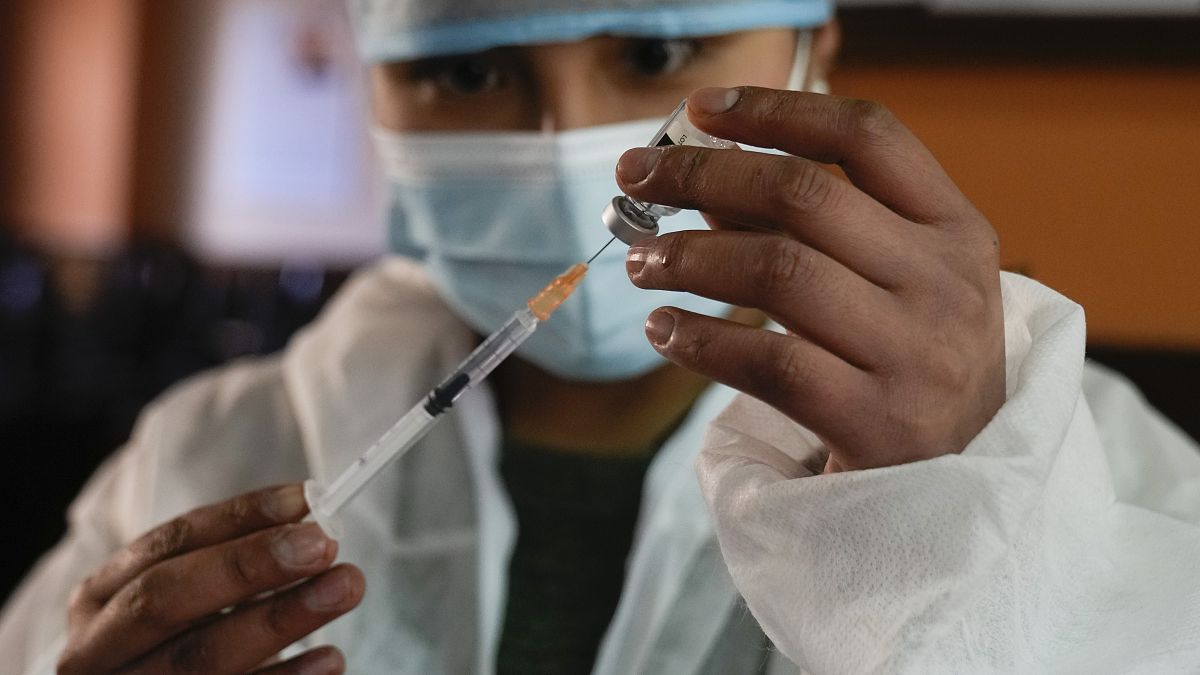 A health worker prepares a shot of the Johnson & Johnson COVID-19 vaccine  in La Paz, Bolivia, Aug. 3, 2021. 