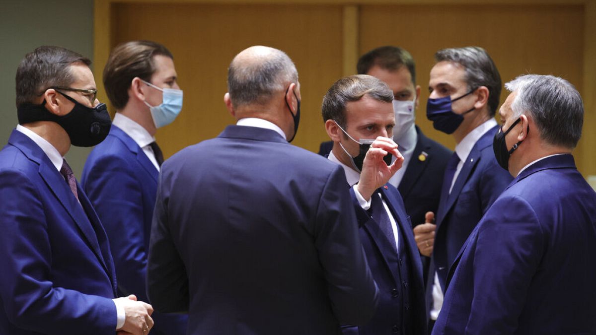 French President Emmanuel Macron, center, speaks with Hungary's Prime Minister Viktor Orban, right