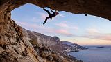 A climber scales a cliff face