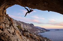 A climber scales a cliff face