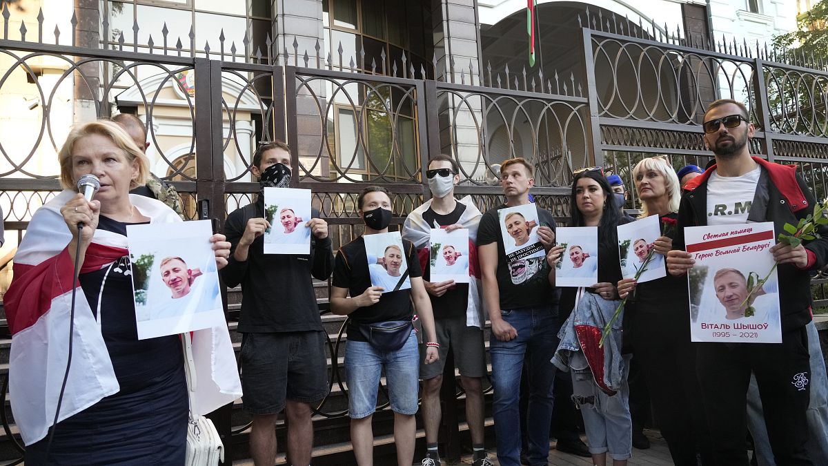 Activists hold portraits of activist Vitaly Shishov, leader of the Belarusian House in Ukraine, during a rally in front of the Belarus Embassy in Kyiv, August 3, 2021. 