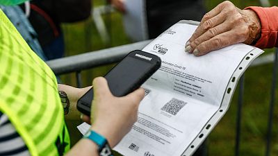 A festival-goer gets their Covid-19 vaccine certificate checked as they arrive on the opening day of the 29th edition of the Les Vieilles Charrues music festival.
