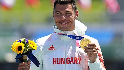 Sandor Totka, of Hungary, holds up his gold medal in the men's kayak single 200m final at the 2020 Summer Olympics