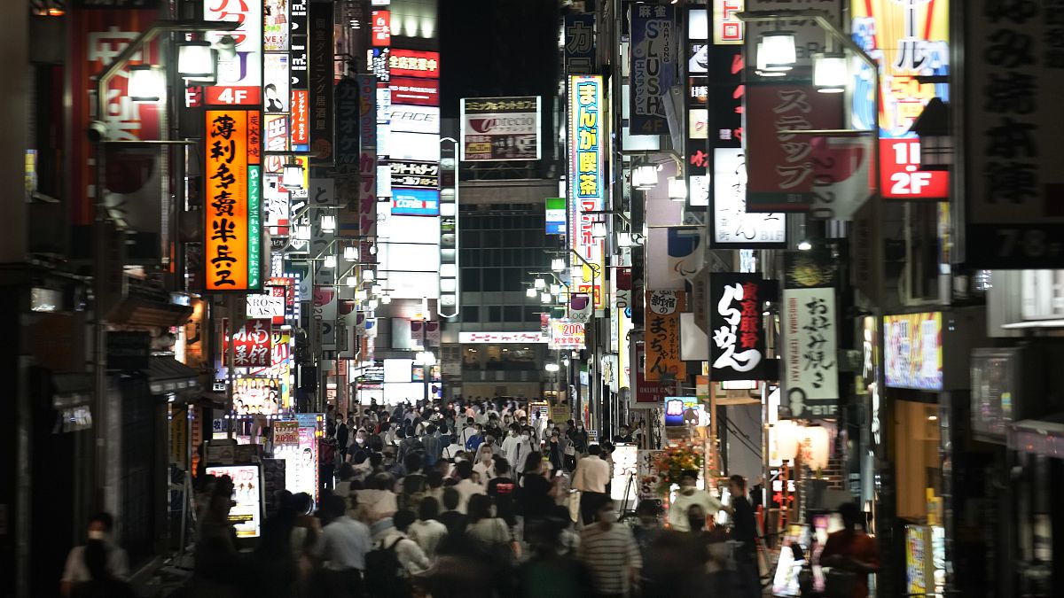 FILE - In this July 16, 2021, file photo, people crowd the street in the Kabukicho area, Tokyo's entertainment district. 