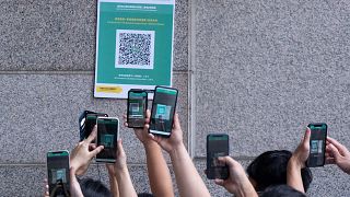 Visitors scan a QR code for the Hong Kong government's "Leave Home Safe" app to trace people in the advent of any Covid-19 outbreaks