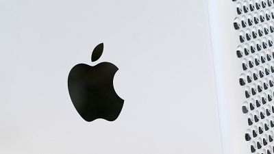 The Apple logo displayed on a Mac Pro desktop computer.