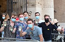 Visitors show their Covid-19 certificates before entering the Ancient Colosseum in Rome on August 6, 2021, as Italy made the Green Pass compulsory.