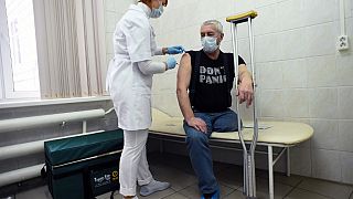 An healthcare worker administers a dose of COVID-19 vaccine at a vaccination centre in Saint Petersburg, as Russia launched a mass vaccination campaign for homeless people.