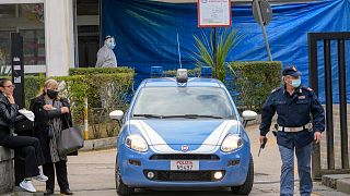 A police car leaves the Cardarelli hospital in Naples, southern Italy, Friday, Nov. 13, 2020.