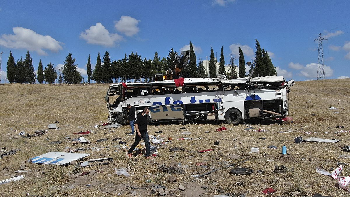 Officials investigate at the site of a bus crash, in Balikesir, western Turkey, Aug. 8, 2021. 