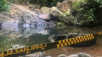 Police tape cordons off the area where a woman was found dead in Phuket, Thailand